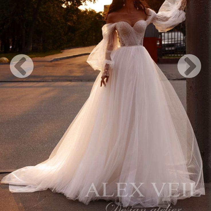 a woman in a wedding dress standing on the street