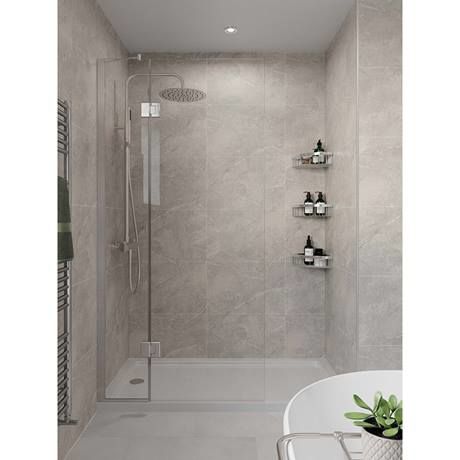 a white bath tub sitting next to a walk in shower with shelves on the wall