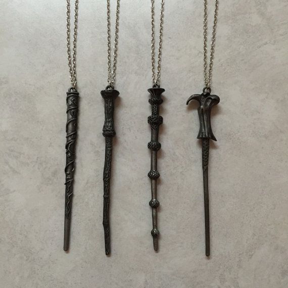 three necklaces that have been made to look like swords