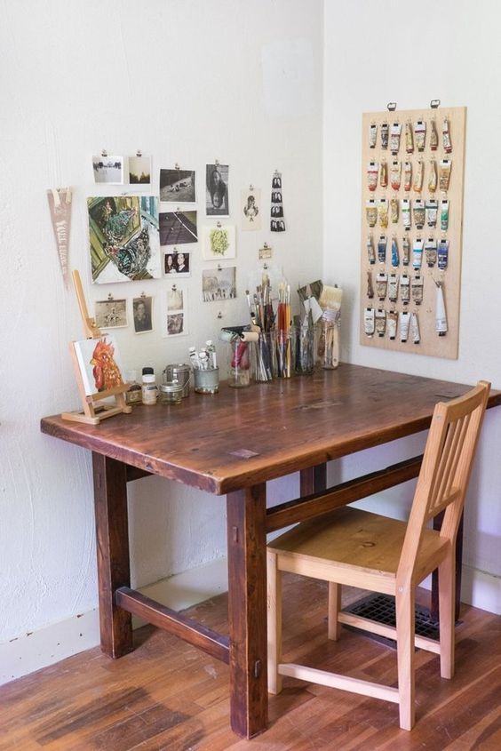 a wooden table with a yellow object sitting on it's centerpiece in front of a white wall