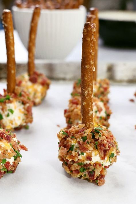 small appetizers are lined up on a white tableclothed surface, ready to be eaten