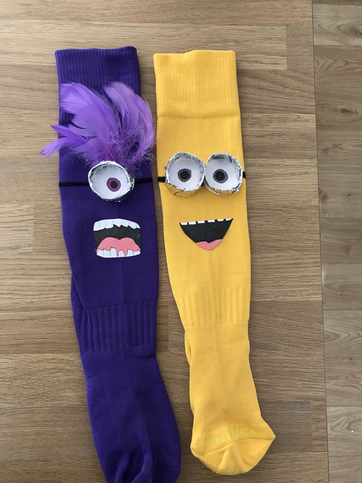 two pairs of purple and yellow socks with googly eyes