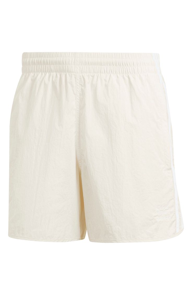 Lightweight and comfortable, these shorts made entirely of recycled fibers sport secure zippered pockets and bright 3-Stripes racing up the sides. 100% recycled polyester Machine wash, line dry Imported This product meets Nordstrom Sustainably Sourced Materials criteria: contains at least 30% sustainably sourced materials Summer Sportswear Bottoms With Three Stripes, Summer Sportswear Shorts With Side Stripes, Three Stripes Sportswear Bottoms For Summer, Sportswear Bottoms With Three Stripes For Summer, Three Stripes Branding Sportswear For Summer, Summer Sportswear Shorts With Three Stripes, Sportswear Shorts With Three Stripes For Spring, Spring Sportswear Shorts With Three Stripes, Summer Athleisure Shorts With Three Stripes Branding