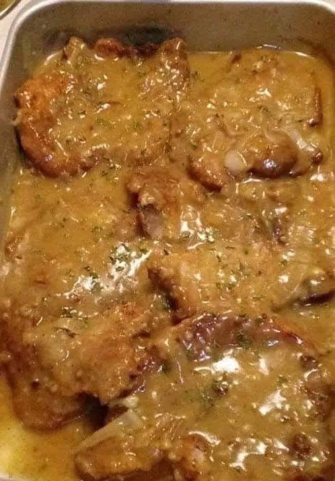 some meat and gravy in a metal pan