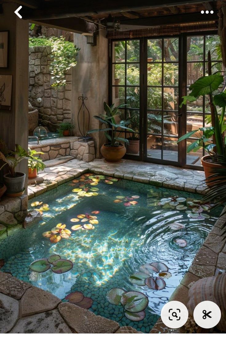 an indoor pool with water lilies in the middle and plants around it on either side