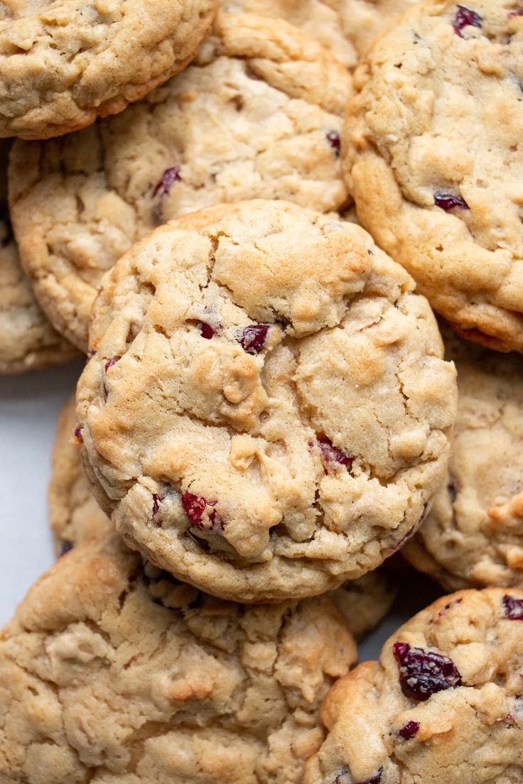 cranberry white chocolate chip cookies stacked on top of each other in a pile