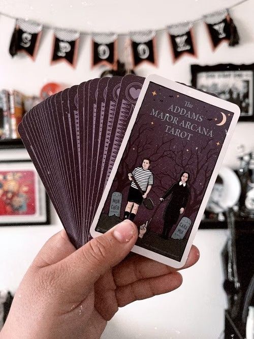 a person holding up some cards in their hand with the caption'add me to marrocan tarot '