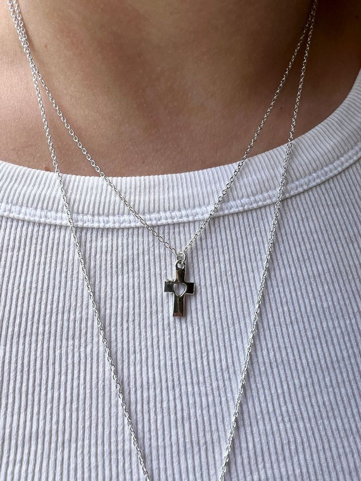 Embrace the timeless elegance and spiritual significance of our small silver cross  necklace. Meticulously crafted for both style and sentiment, this dainty necklace is the perfect accessory for everyday wear or special occasions. Product Features: 🌟Elegant Design: The cross pendant, a universal symbol of faith and hope, is elegantly crafted in high-quality plated sterling silver. The sleek and minimalist design ensures it complements any outfit, from casual to formal. 🌟 Perfect Length: The pendant is suspended on an 18'' sterling silver chain, providing a flattering length that sits gracefully on the collarbone. This versatile length is ideal for layering with other necklaces or wearing on its own. 🌟 Quality Material: Made from sterling silver plated chain, this necklace is hypoallerge Sterling Silver Necklace With Delicate Cross Pendant, Minimalist Crucifix Jewelry With Delicate Chain, Dainty Cross Necklace For Everyday Wear, Silver Crucifix Necklace For Everyday, Everyday Silver Crucifix Jewelry, Silver Crucifix Jewelry For Everyday Wear, Minimalist Hypoallergenic Cross Jewelry, Minimalist Crucifix Charm Necklace As Gift, Dainty Silver Crucifix Necklace