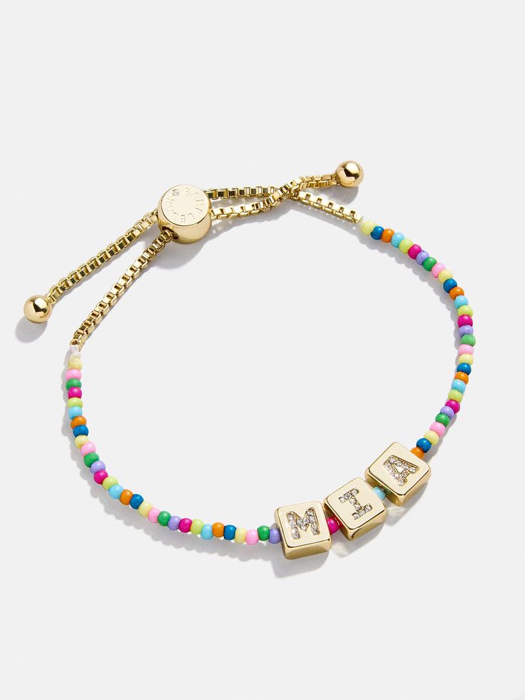 Add a pop of fun to your little one's style with our Custom Beaded Bracelet. This pull-tie bracelet can be personalized with your kid's name, or with a special phrase they adore. Either way, the letters shimmer with glass stones. It's a colorful and unique accessory your mini me will never want to take off. All of our custom mini bracelets grow as your little one does — either via stretch fit, or adjustable pull tie.Please note: intended for children 3+. Trendy Adjustable Custom Name Jewelry, Trendy Adjustable Jewelry With Custom Name, Trendy Letter Beads Jewelry For Birthday, Trendy Bracelets For Mother's Day, Trendy Personalized Name Bracelet For Mother's Day, Adjustable Name Bracelet With Colorful Beads, Adjustable Letter Beads Friendship Jewelry, Trendy Personalized Charm Bracelet For Birthday, Trendy Beaded Bracelets With Letter Beads For Birthday