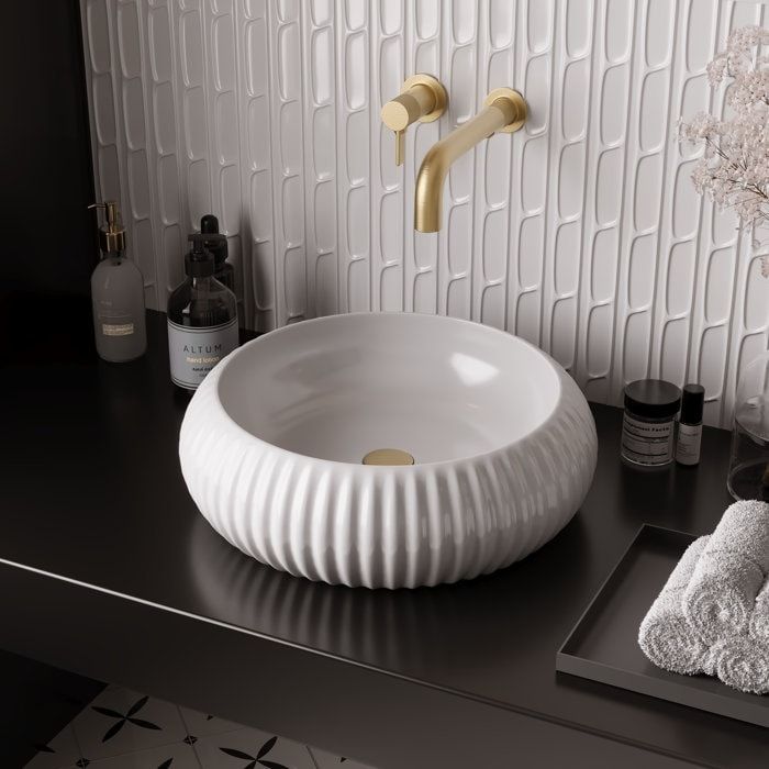 a bathroom sink sitting on top of a black counter