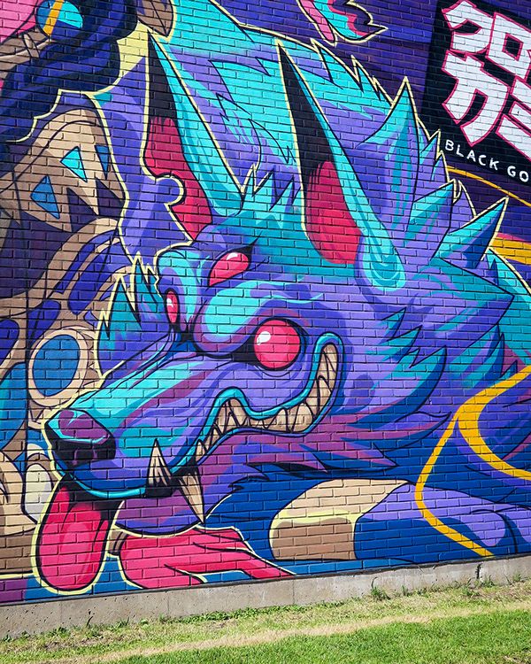 a colorful dragon painted on the side of a building