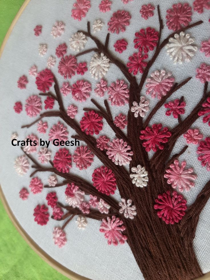 a hand embroidered tree with pink and white flowers