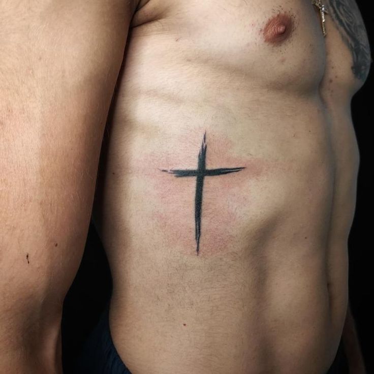 a man with a cross tattoo on his chest