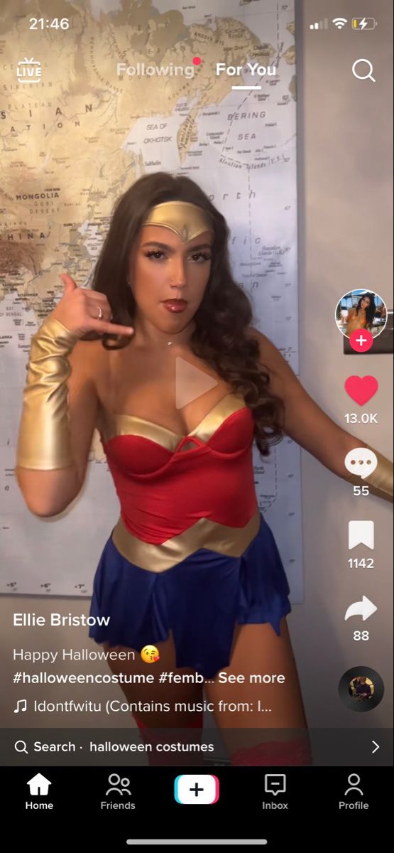 a woman in a wonder costume standing next to a map and pointing her finger at the camera