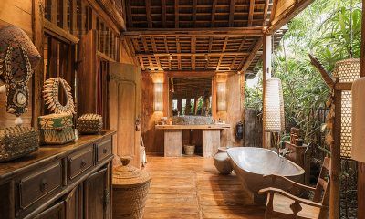 a bathroom with a tub, sink and mirror in it's centerpieces