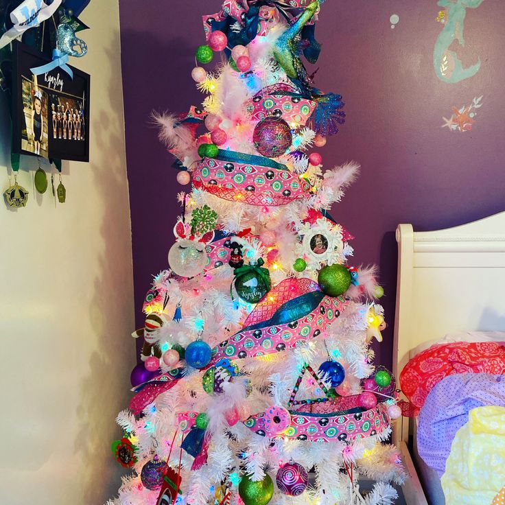 a brightly colored christmas tree in a child's bedroom