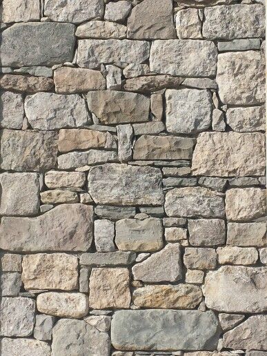 a stone wall made out of several different types of rocks