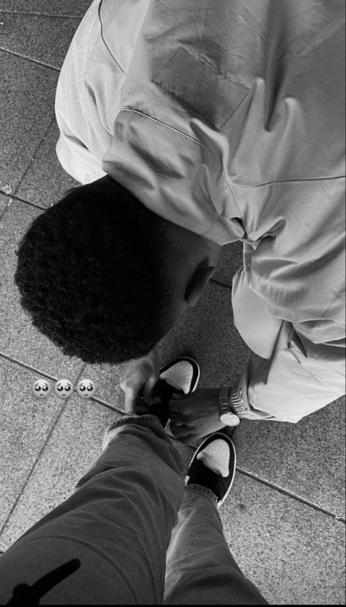 a man standing on top of a tile floor next to a person with black hair