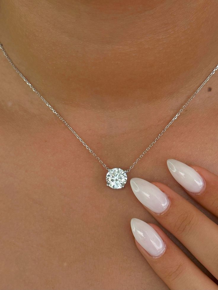 This Beautiful timeless floating prong set diamond pendant is set with 1-carat lab-grown diamond in 14k solid gold. It will be the classic perfect gift for any woman in your life--whether she's your wife, girlfriend, fiancée, or bride. The pendant and chain are made of 14k solid gold and feature a spring clasp. The necklace is available for purchase with or without an IGI certificate. All of our diamonds are high-quality D color, VS1 clarity. Each diamond is securely set in a Prong setting, radiating sophistication with every glance. Every diamond is expertly positioned to reflect maximum light and brilliance that tells your forever love story. Item Details: 14k solid gold pendant and chain Chain length: 16 inches up to 18 inch Diamond: CVD lab-grown diamonds  Total Weight: 1 carats Cut: R Pendant Necklace Diamond, Solitaire Necklace, Solid Gold Necklace, Diamond Solitaire Necklace, Solitaire Necklaces, Gold Diamond Necklace, Necklace Diamond, 14k Gold Necklace, Diamond Pendant Necklace