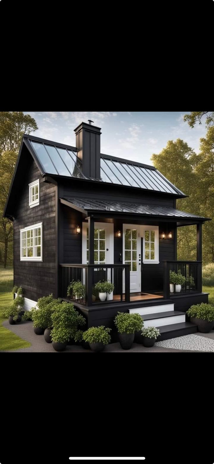 a small black and white house with a porch