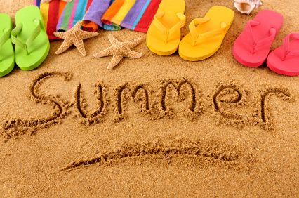 a welcome sign is written in the sand with flip flops and starfish