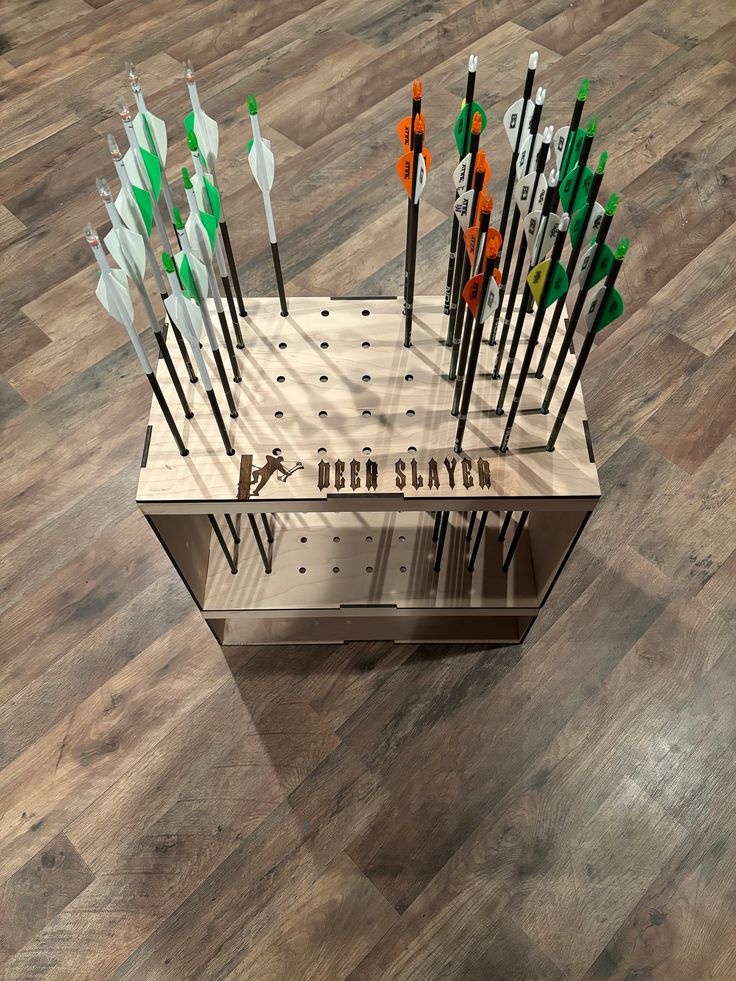 a display case with several different types of arrows in it on a wooden floor that says deep sky