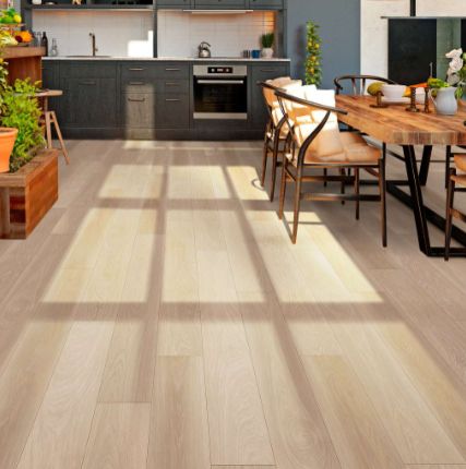 an open kitchen and dining room with wood flooring