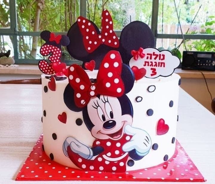 a mickey mouse birthday cake on a table