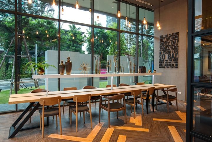 a dining room with large windows and wooden tables in front of it, along with chairs