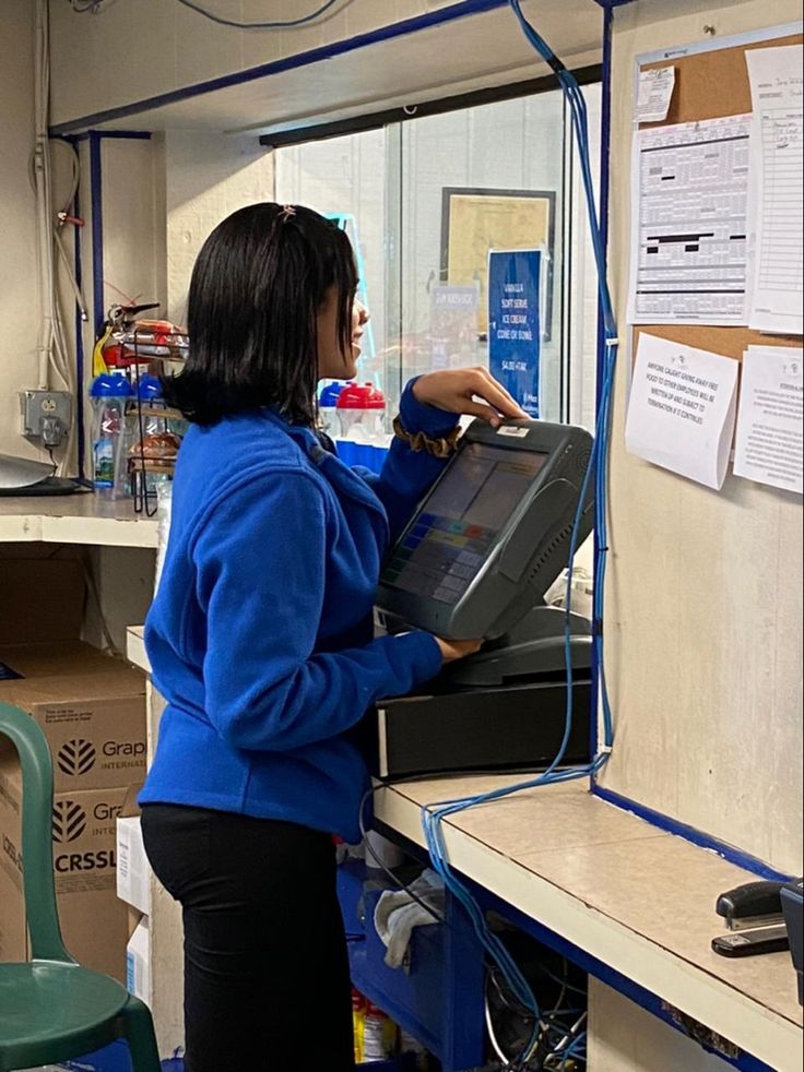 a woman standing in front of a computer screen