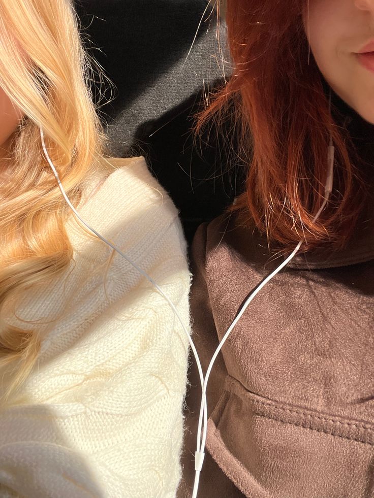 two women with ear buds on their ears