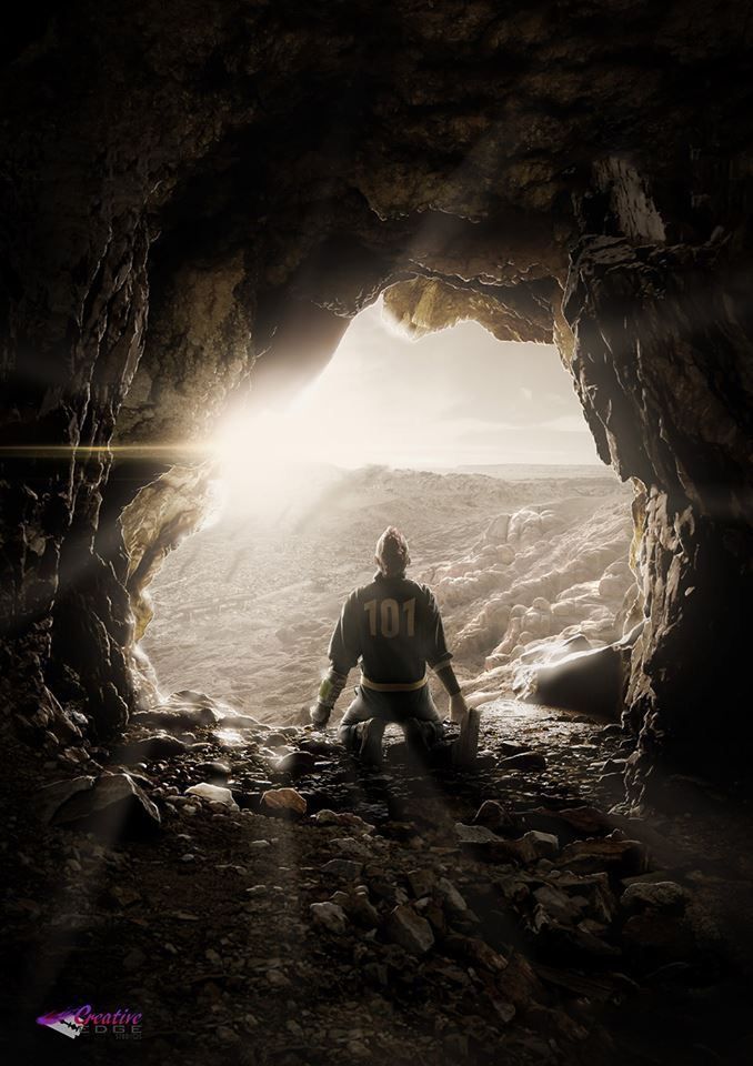 a man sitting in the middle of a cave