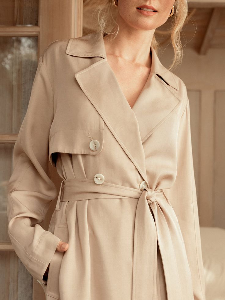 If there ever was a perfect lightweight trench, this is it. Made of a luxurious and flowy fabric, it's a stunning layering piece and can also be worn buttoned up as a dress. The color lies beautifully between beige and tan, providing a soft neutral tone that goes with literally anything in your closet, including all of our capsule pieces. With a tie belt, beautiful horn style buttons, lovely pleats, side slits and a back flap, its intentional design is what sets us apart. Whatever you pair this Toddler Boots, Long Sleeve Kids, Boys Bottoms, Belted Trench Coat, Shirt Sale, Kids Tops, Tie Belt, Dress With Boots, Coats Jackets Women