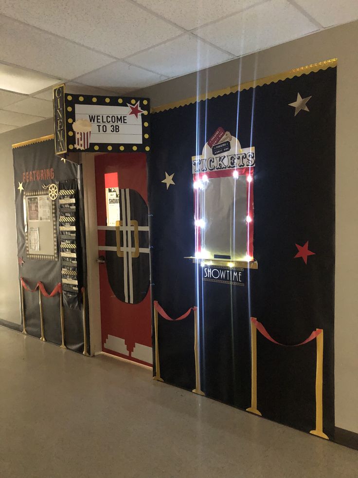 an office hallway decorated with black and red door covers, white stars and neon lights