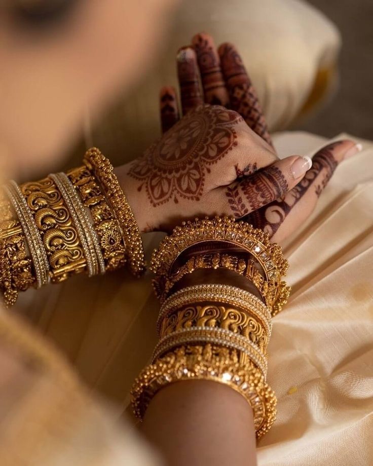 a woman's hands with hennap and bracelets