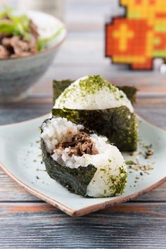 two sushi rolls on a white plate