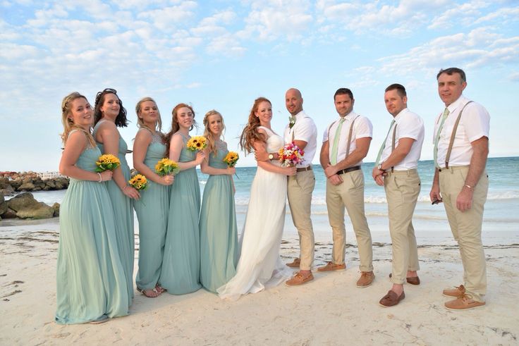 a group of people standing next to each other on a beach