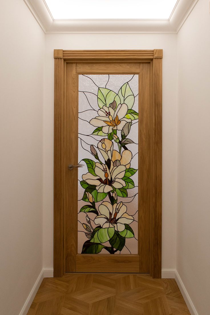 a wooden door with stained glass flowers on it