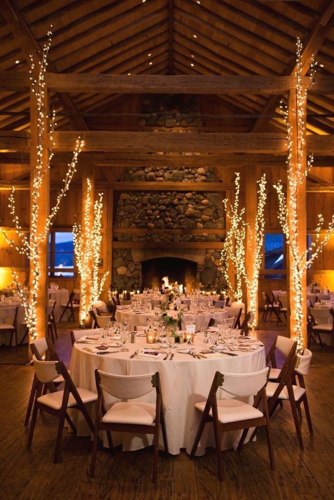 the tables are set with white linens and lit candles for an elegant wedding reception