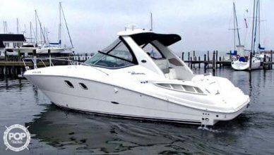 a white boat is in the water near some boats