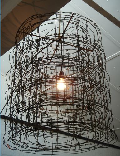 a light that is hanging from the ceiling with wires attached to it's sides