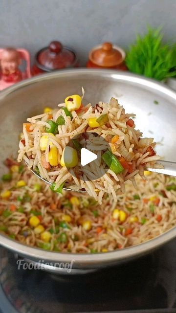 a bowl filled with rice and vegetables on top of a stove