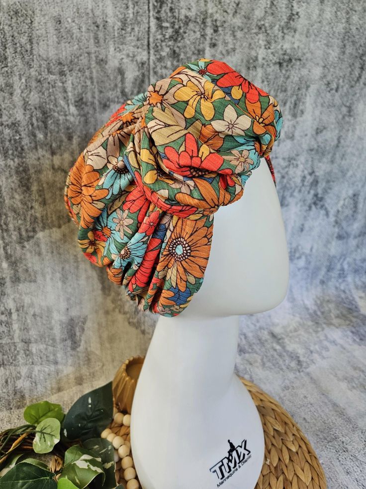 Our Retro Fall Floral Print Ruffle Front Turban is made of soft and stretchy ribbed knit for comfortable all day wear. Wrap Happy and create YOUR perfect fit with your choice of sizes and finishes. No need to wear a full scarf or hassle with complicated wrapping techniques- this fabulous look is already done for you! Get perfect styling in a flash -just pull it on and go!  Fits: Bare Fit- worn over no hair Hair Fit- worn with hair Shaper Fit- worn over shaper or volumizer. If choosing Shaper Fit, please measure your head with shaper ON for the best fit. See Measuring Pic. Styles: Cinch Front Ruffle Front Available in:  21.5"  22.5" 23.5" Custom If you need a size different from those listed, please choose "Custom", and leave a note at checkout.  Measure from your forehead around to the bas Bohemian Spring Beach Turban, Spring Headwrap One Size Fits All Headband, One Size Headwrap Headband For Spring, One Size Spring Headband Headwrap, Adjustable Multicolor Headband Headscarf, Multicolor Summer Turban, One Size Fits Most, Bohemian Adjustable Headscarf With Matching Headband, Bohemian Fitted Headscarf Headband, Spring Headwrap With Matching Headband