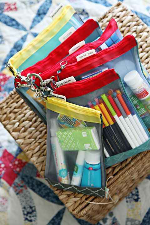 a basket filled with lots of different types of pens and pencils on top of a bed