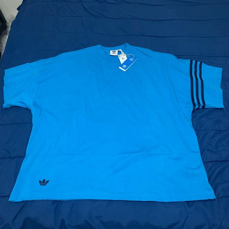 Brand New, Blue Adidas Shirt, Size Xl , Material Heavy Duty Long Lasting Soft Material , Cotton Blue T-shirt With Three Stripes Branding For Streetwear, Blue Sporty Short Sleeve Shirt, Sporty Short Sleeve Blue Shirt, Sporty Blue Short Sleeve Shirt, Blue Short Sleeve Sporty Shirt, Relaxed Fit Short Sleeve Tops With Three Stripes, Blue Short Sleeve T-shirt With Three Stripes, Blue Cotton T-shirt With Three Stripes, Blue Cotton Tops With Three Stripes