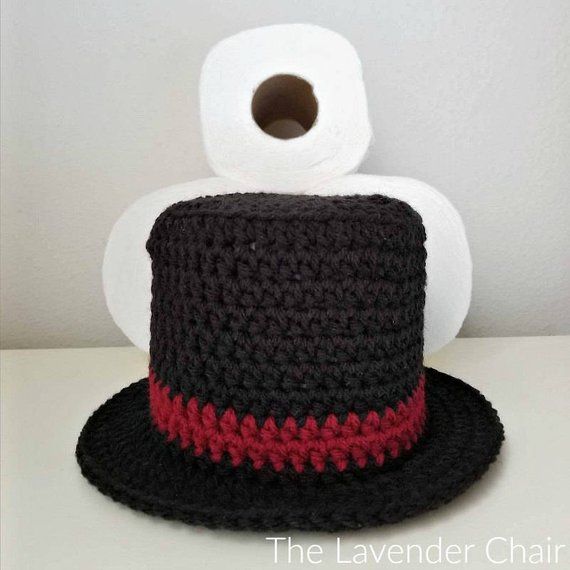 a crocheted hat with a roll of toilet paper in the back and on top