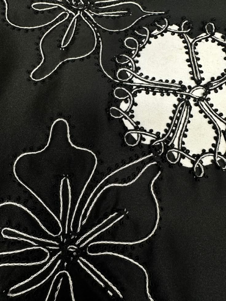 black and white embroidered fabric with flowers on it