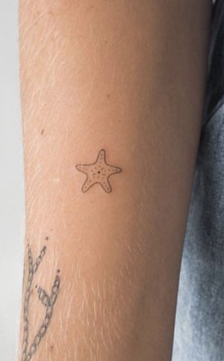 a person with a starfish tattoo on their arm