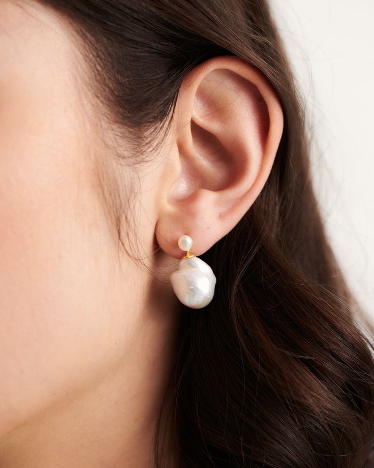 Redefine expectations with our feminine Genova pearl earrings. Combining classic with a touch of something more unique - this bold duo is what we call a modern heirloom. Hair up or down - the Genova earrings will perfectly accentuate your every look. 

Break the mould & pair with the Champagne Necklace to prove once again that beauty is so much more than perfection. 
Details

Handcrafted in a thick layer of 18k gold on sterling silver2 genuine 11-13 mm freshwater baroque drop pearls & 4 mm keshi Timeless Teardrop Pearl Pendant Earrings, Formal Drop Pearl Earrings, Modern Pearl Charm Earrings For Wedding, Modern Pearl Drop Earrings For Wedding, Modern Pearl Earrings For Wedding, Modern Teardrop Pearl Earrings For Formal Occasions, Timeless Teardrop Pearl Earrings, Classic Drop Earrings With Pearl Chain, Modern Pearl Chain Earrings For Wedding