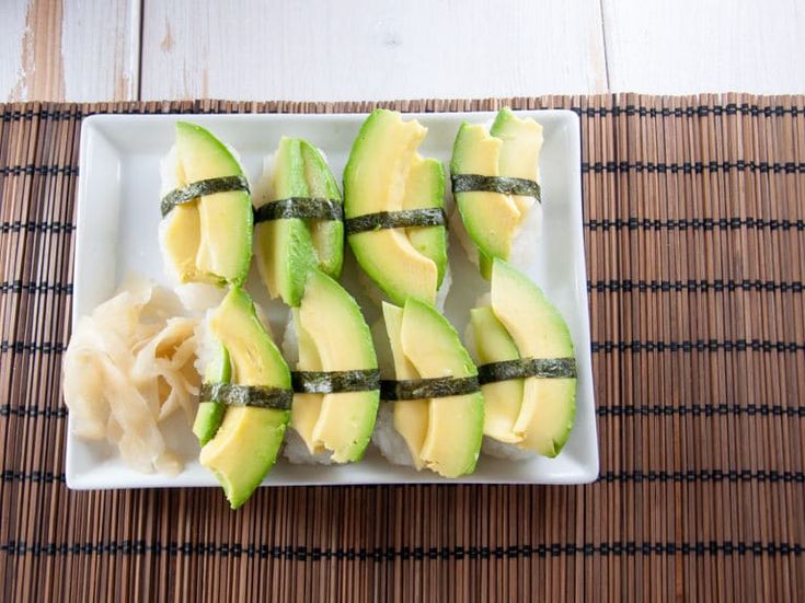 an avocado cut in half on a plate with some sort of garnish